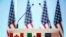 FILE - The flags of Canada, Mexico and the U.S. are seen on a lectern before a joint news conference during NAFTA talks in Mexico City, Mexico, March 5, 2018. 