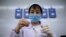 FILE - A technician examines a vile at a laboratory in Shenyang, in China's northeast Liaoning province, June 9, 2020.  