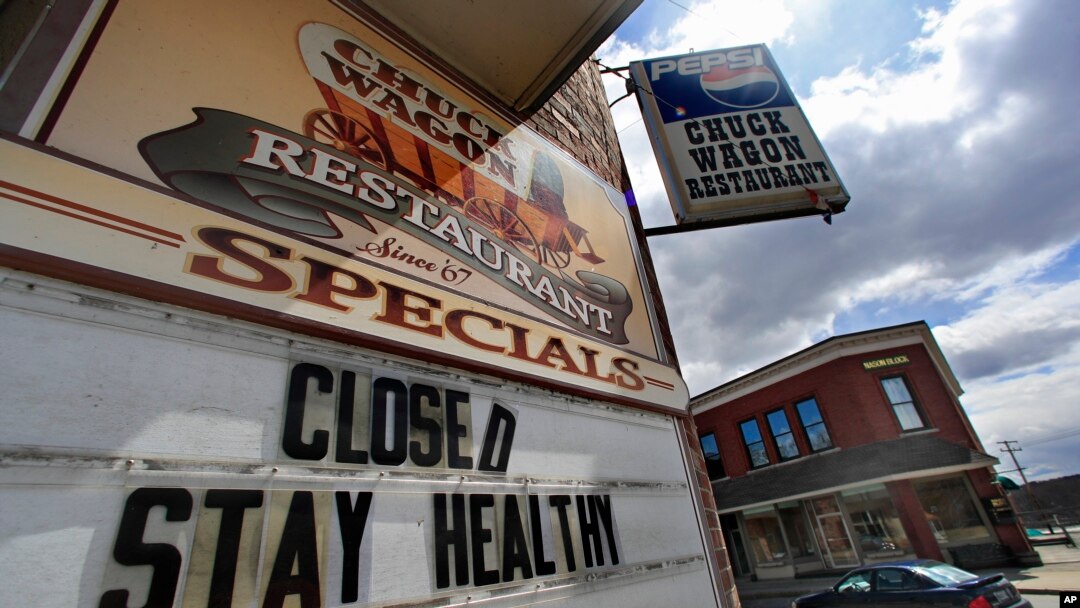 FILE - A sign announces a coronavirus closure at a restaurant in Livermore Falls, Maine, April 16, 2020. 