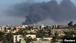 Smoke rises during a fight between members of the Libyan internationally recognized government forces and Eastern forces in Ain Zara, Tripoli, Libya, May 5, 2019.