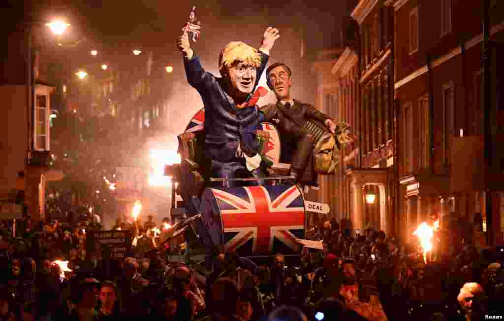 Effigies of Britain&#39;s Prime Minister Boris Johnson and Leader of the House of Commons Jacob Rees-Mogg are paraded through the town during the annual Bonfire Night festivities in Lewes, Britain, Nov. 5, 2019.