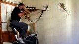 A Free Syrian Army fighter takes a position as he aims his weapon at the Justice Palace, which is controlled by forces loyal to Syria&#39;s President Bashar al-Assad, in Aleppo. 