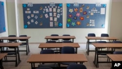 FILE - An empty classroom is seen at a school in the central Israeli city of Ramle, Sept. 22, 2015.