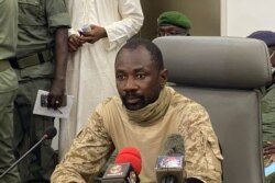 Colonel Assimi Goita speaks to the press at the Malian Ministry of Defense in Bamako, Mali, Aug. 19, 2020.