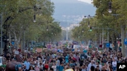 People march during a worldwide protest demanding action on climate change in Barcelona, Spain, Sept. 27, 2019.