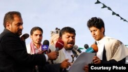Radwan al-Haimi (R) holds a microphone as Mohammed Ali al-Houthi, President of the Houthi’s Revolutionary Committee, speaks to the media, January 23, 2015. (Photo courtesy of Radwan al-Haimi, Sana’a, Yemen.)