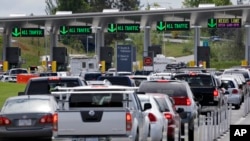 FILE - In this Thursday, May 23, 2013 photo, cars from Canada line up to cross into the U.S. in Blaine, Washington.