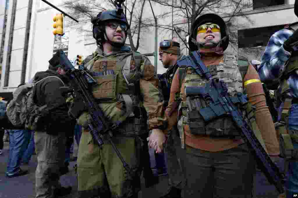 Demonstrators stand outside a security zone before a pro-gun rally in Richmond, Virginia.