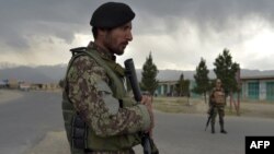 Afghan National Army soldiers stand guard at a checkpoint