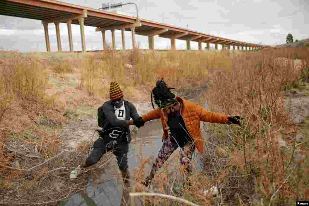 Migrants cross the Rio Bravo river to turn themselves in to request for asylum in El Paso, Texas, as seen from Ciudad Juarez, Mexico, Feb. 1, 2021.
