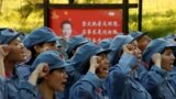 Participants dressed in replica red army uniforms swear an oath during a Communist team-building course extolling the spirit of the Long March in the mountains outside Jinggangshan, Jiangxi province, China, September 14, 2017. 