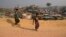 FILE - Rohingya refugees carry a hume pipe in Balukhali refugee camp near Cox's Bazar, in Bangladesh, Nov. 17, 2018. 
