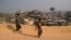 Rohingya refugees carry a hume pipe in Balukhali refugee camp near Cox's Bazar, in Bangladesh, Nov. 17, 2018. 