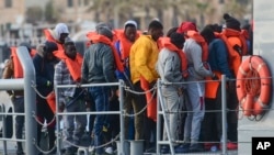 Migrants disembark after being transferred to Maltese army boats at sea and brought to Valletta harbor, Malta, April 13, 2019. 