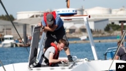 FILE - Technicians check the hull and interior of the Mayflower Autonomous Ship at its launch site for it's first outing on water since being built in Turnchapel, Plymouth south west England, Sept. 14, 2020. 