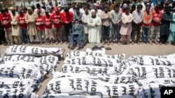 FILE - In this June 26, 2015 file photo, mourners attend a funeral for unclaimed people who died of extreme weather, in Karachi, Pakistan, after a devastating heat wave that struck southern Pakistan the previous weekend, with over 800 confirmed deaths.