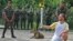 An athlete holds the Olympic Torch by a jaguar during a ceremony in Manaus, northern Brazil, June 20, 2016. The jaguar, who was named Juma and lived in the local zoo, had to be shot dead by soldiers shortly after the ceremony when he escaped.