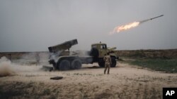 FILE - A rocket is fired from a rocket launcher outside Makhmour, about 75 km (47 miles) east of Mosul, Iraq, March 25, 2016.