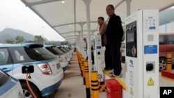 New electric-powered taxis are charged at a public charging station in Shenzhen city, south China's Guangdong province, Jan. 7, 2019.