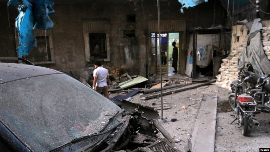 Medics inspect the damage outside a field hospital after an airstrike in the rebel-held al-Maadi neighbourhood of Aleppo, Syria, Sept. 28, 2016. 