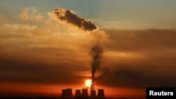 FILE - Sun rises behind the cooling towers of Kendal Power Station, a coal-fired station of South African utility Eskom, as the company's ageing coal-fired plants cause frequent power outages, near Witbank, in the Mpumalanga province, South Africa January 17, 2023.