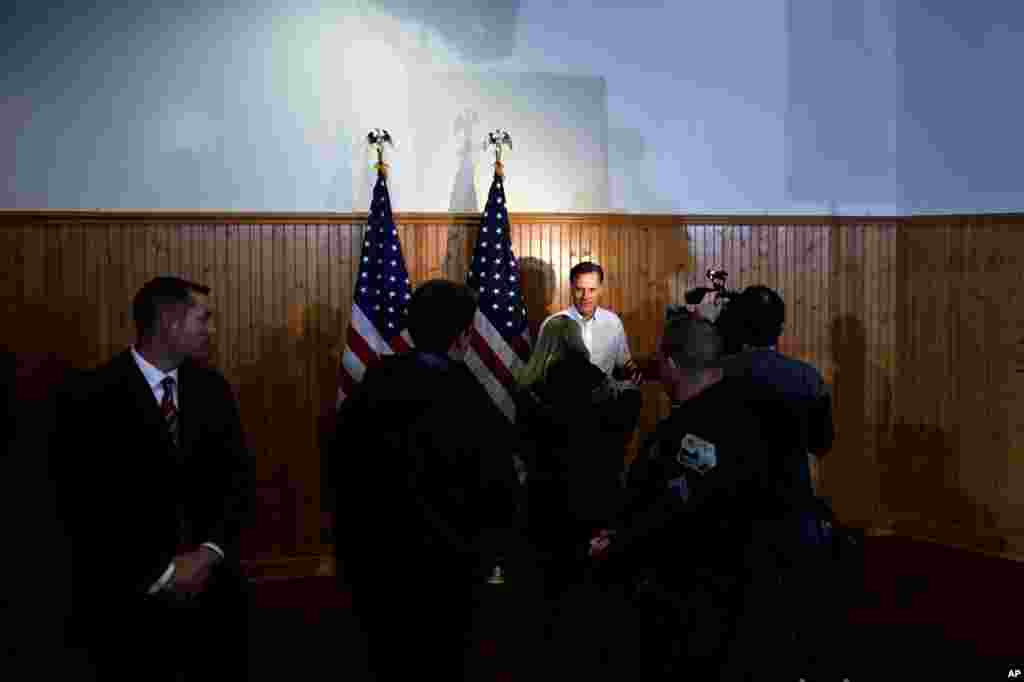 Mitt Romney is interviewed as he campaigns at the Mississippi Valley Fairgrounds in Davenport, Iowa, Jan. 2, 2012. (AP)