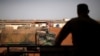 FILE - A French soldier is silhouetted as he looks out over military vehicles in Gao, Mali, Aug. 1, 2019. 