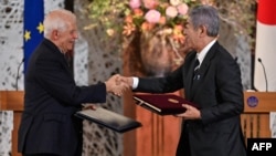 European Union foreign policy chief Josep Borrell, left, and Japanese Foreign Minister Takeshi Iwaya shake hands following a signing ceremony at the Iikura Guest House in Tokyo, Nov. 1, 2024.