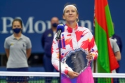 Victoria Azarenka, of Belarus, holds the runner-up trophy after losing to Naomi Osaka, of Japan, in the women's singles final of the U.S. Open tennis championships, Sept. 12, 2020, in New York.