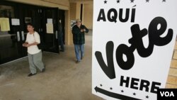 FILE - Hispanic voters leave a San Antonio, Texas, polling place after voting in the 2004 election.