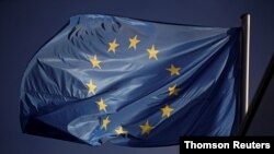 An European Union flag flutters above the Germany's Christian Democratic Union party (CDU) headquarters after first poll results of the European Parliament elections in Berlin, Germany, May 26, 2019. 