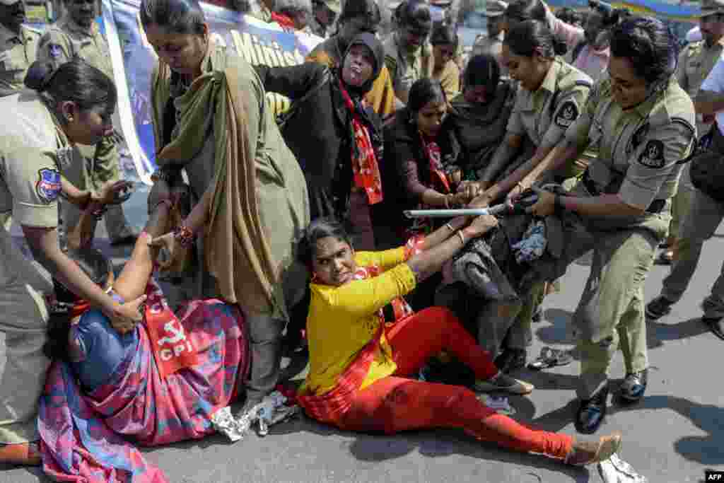 Police detain members of Communist Party of India (CPI) as they demand the resignation of Union Home Minister Amit Shah to take responsibility for the violence in Delhi, during a protest in Hyderabad, India.
