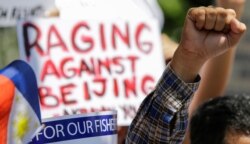 Protesters rally outside the Department of Foreign Affairs in Manila, Philippines, June 21, 2019, after a recent incident of a Chinese fishing vessel hitting a Filipino fishing boat.