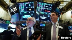 FILE - Traders work on the floor of the New York Stock Exchange.