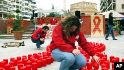 A medical student lights candles forming the shape of a big red bow, symbol of AIDS awareness, to mark World AIDS Day in the northern Greek port city of Thessaloniki. (File)