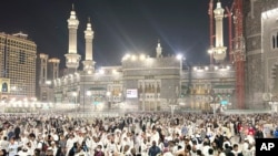 Pilgrims leave after offering prayers outside at the Grand Mosque during the annual Hajj pilgrimage in Mecca, Saudi Arabia, June 14, 2024.