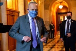 FILE - Senate Majority Leader Chuck Schumer of N.Y., heads to an interview on Capitol Hill in Washington, Jan. 25, 2021.