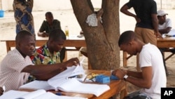 Election workers prepare electoral cards for the Benin's Presidential election in Yenawa, eastern Cotonou on March 2, 2011