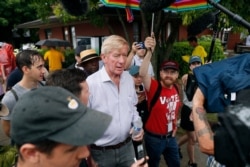FILE - Republican presidential candidate and former Massachusetts Gov. Bill Weld, center, walks to the grand concourse during a visit to the Iowa State Fair, in Des Moines, Iowa, Aug. 11, 2019.