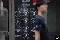 An ad for a shop in Chinese is seen at Ikebukuro district, popular among Chinese living in Japan, Sept. 4, 2024, in Tokyo. Human Rights Watch said Chinese authorities often try to intimidate activists in Japan by targeting their relatives in China.