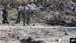 صومالی پولیس اہل کار خودکش حملے کے مقام پر شواہد اکھٹے کر رہے ہیں۔ 4 جولائی 2020