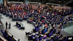 FILE - German Chancellor Olaf Scholz speaks during a plenary session at the German parliament Bundestag where he faces a vote of confidence, Berlin, Germany, Dec. 16, 2024.