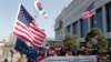 FILE - Demonstrators stage a rally welcoming the visit of U.S. Defense Secretary Lloyd Austin and Secretary of State Antony Blinken outside the Defense Ministry in Seoul, South Korea, March 17, 2021.
