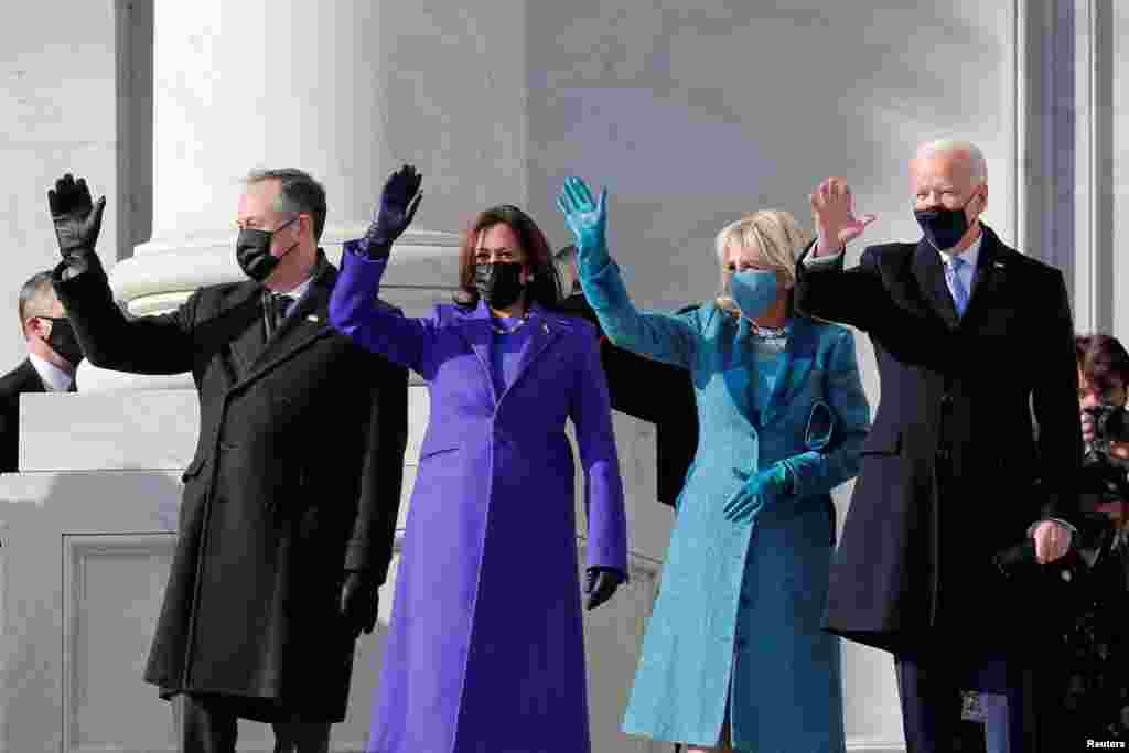 President-elect Joe Biden, his wife Jill Biden, Vice President-elect Kamala Harris and her husband Doug Emhoff salute as they arrive ahead of the inauguration of Biden, in Washington, Jan. 20, 2021. 