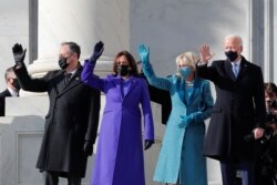 President-elect Joe Biden, his wife Jill Biden, Vice President-elect Kamala Harris and her husband Doug Emhoff salute as they arrive ahead of the inauguration of Biden, in Washington, Jan. 20, 2021.