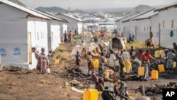 FILE—People displaced by the ongoing fighting between Congolese forces and M23 rebels gather in a camp on the outskirts of Goma, DRC, March 13, 2024.