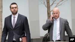 Michael Cohen's attorneys Todd Harrison (R) and Joseph Evans arrive at Federal court, April 13, 2018, in New York. 