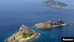FILE - A group of disputed islands, Uotsuri island (t), Minamikojima (b) and Kitakojima, known as Senkaku in Japan and Diaoyu in China is seen in the East China Sea, in this photo taken by Kyodo September 2012.