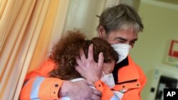 Nurse Elena Betti reacts after receiving the Pfizer-BioNTech COVID-19 vaccine at the Careggi hospital in Florence, Italy.