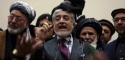 Afghan presidential candidate Abdullah Abdullah, center, addresses the media following a conference with his party members, in Kabul, Feb. 18, 2020.